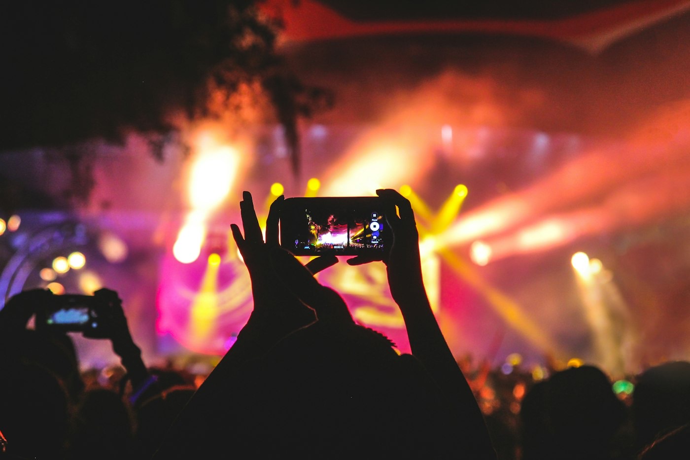 A person filming a crowd on their phone